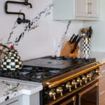 Painted gray kitchen cabinets with black range