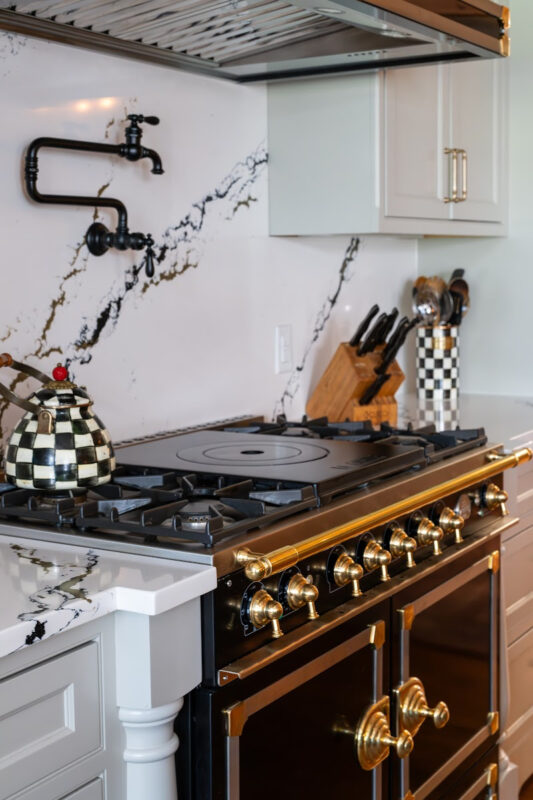 Painted gray kitchen cabinets with black range