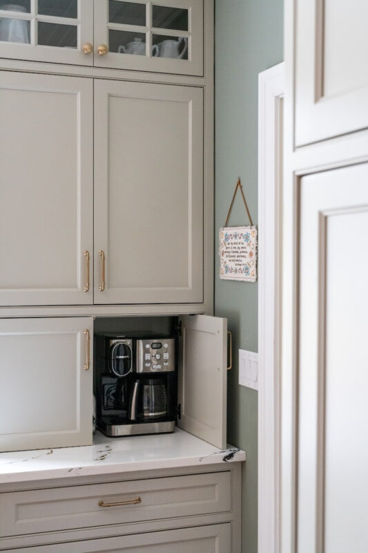 Painted gray kitchen cabinets with appliance storage door open