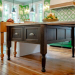 Island furniture cabinet in walnut with Tawny stain and extended countertop.