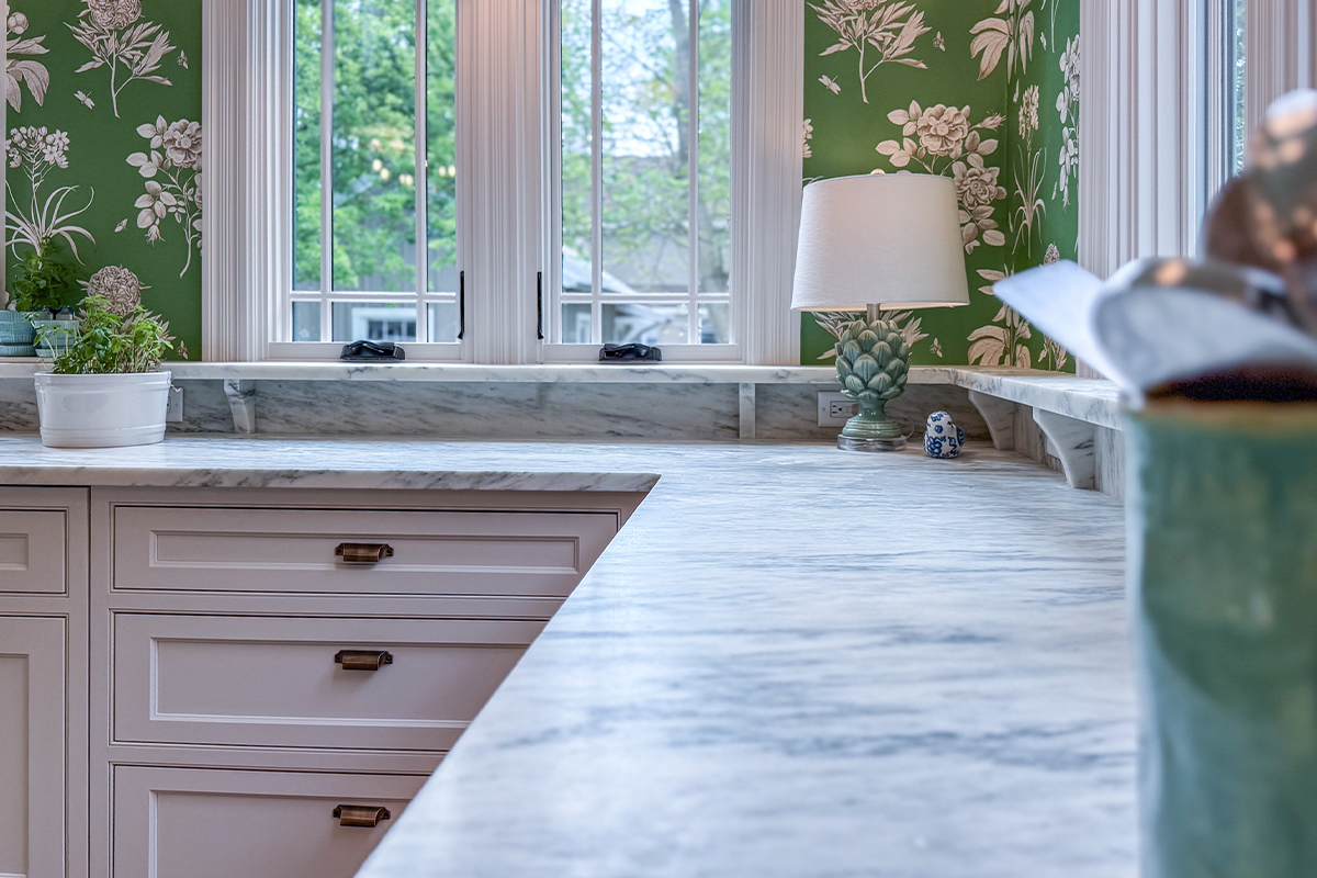 White kitchen cabinets. View of window and counter top.