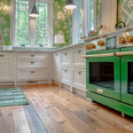 White kitchen cabinets with stainless steel professional range.
