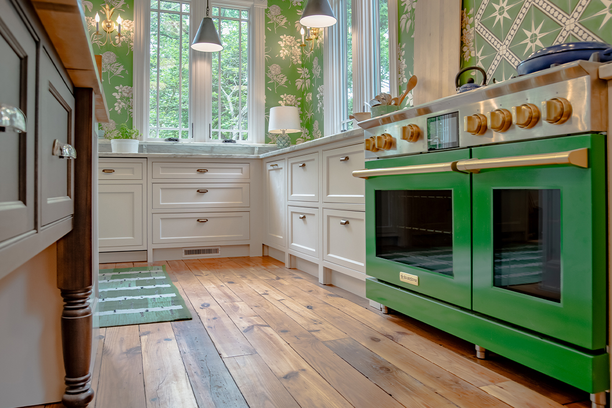 White kitchen cabinets with stainless steel professional range.