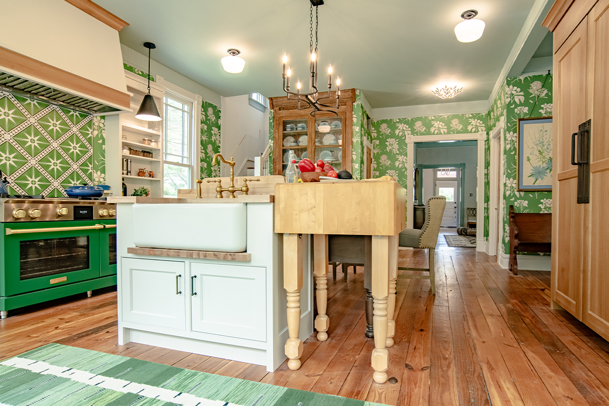 Custom cream paint colored island with natural wood extension furniture cabinet.