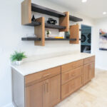 Light brown Sable stained cabinets with a unique floating shelf system above.
