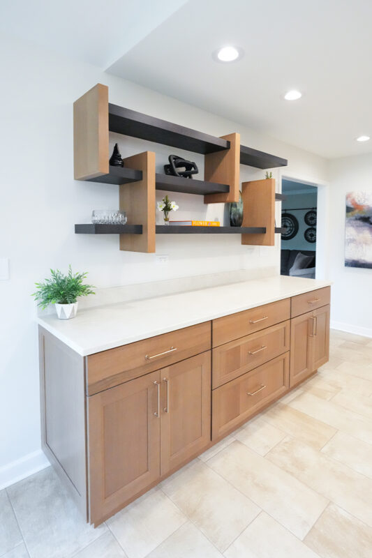 Light brown Sable stained cabinets with a unique floating shelf system above.