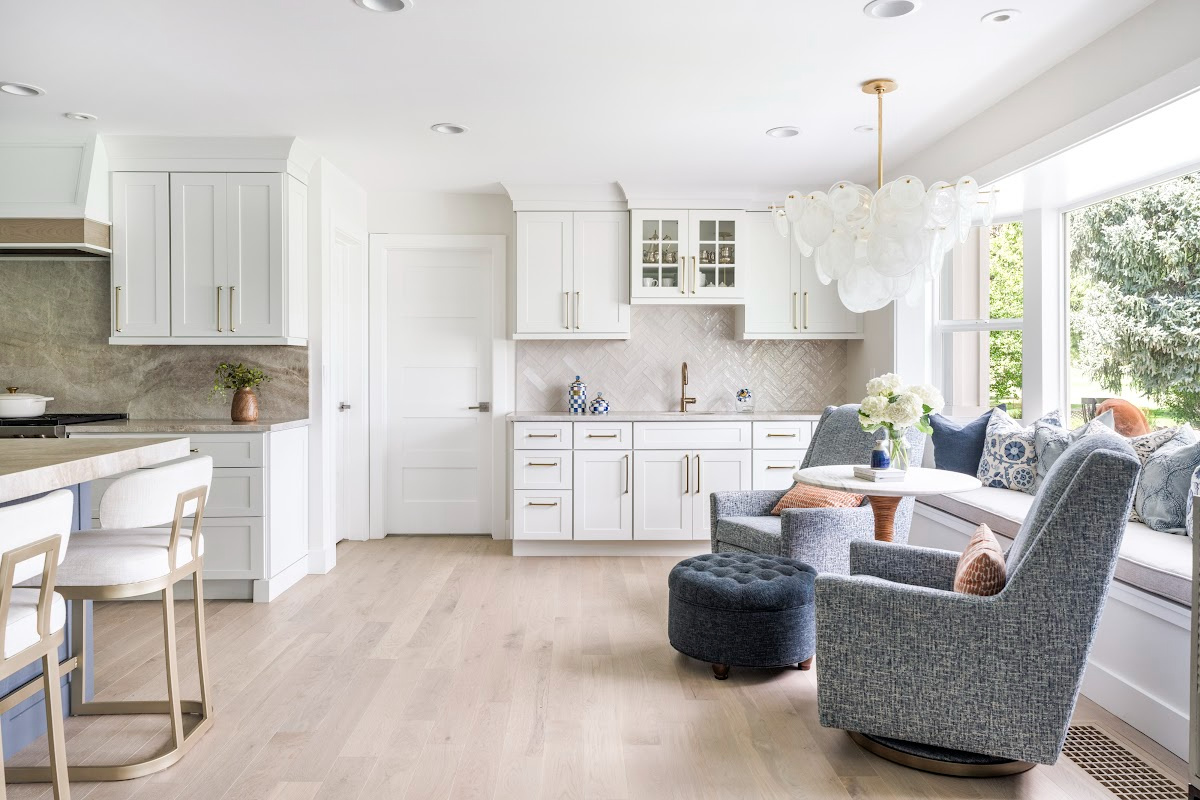 Kitchen with white perimeter and blue island cabinets.