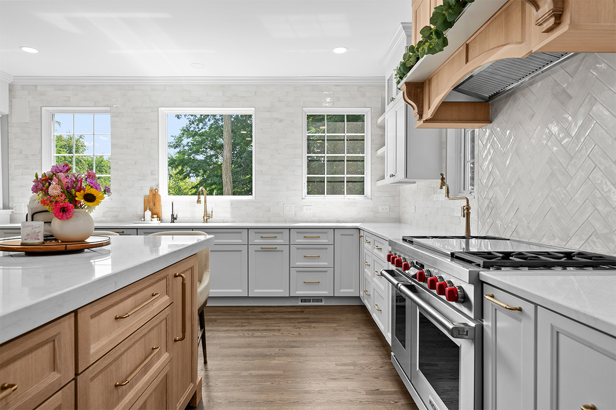 kitchen with white perimeter and stained rift white oak island cabinets.