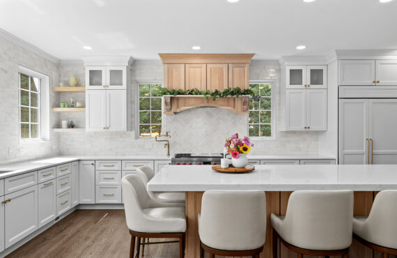 kitchen with white perimeter and stained rift white oak island cabinets.