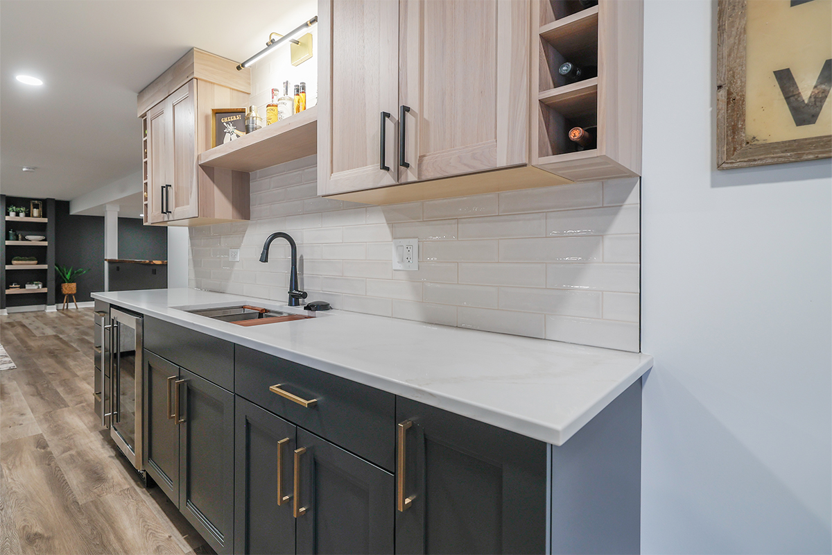 Contemporary kitchen with cabinets in light stain and blue paint.
