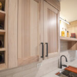 Contemporary kitchen with cabinets in light stain.