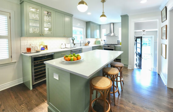 Light green painted kitchen with island.