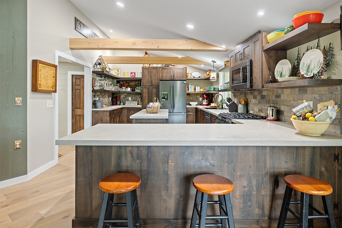 Rustic Alder kitchen with ceiling beams and floating shelves.