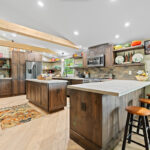 Rustic Alder kitchen with ceiling beams and floating shelves.