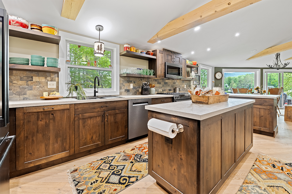 Rustic Alder kitchen with ceiling beams and floating shelves.