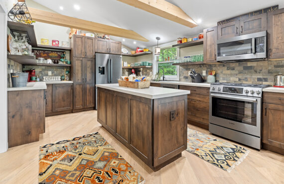 Rustic Alder kitchen with ceiling beams and floating shelves.