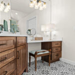 Brown-stained bathroom vanity with makeup desk.