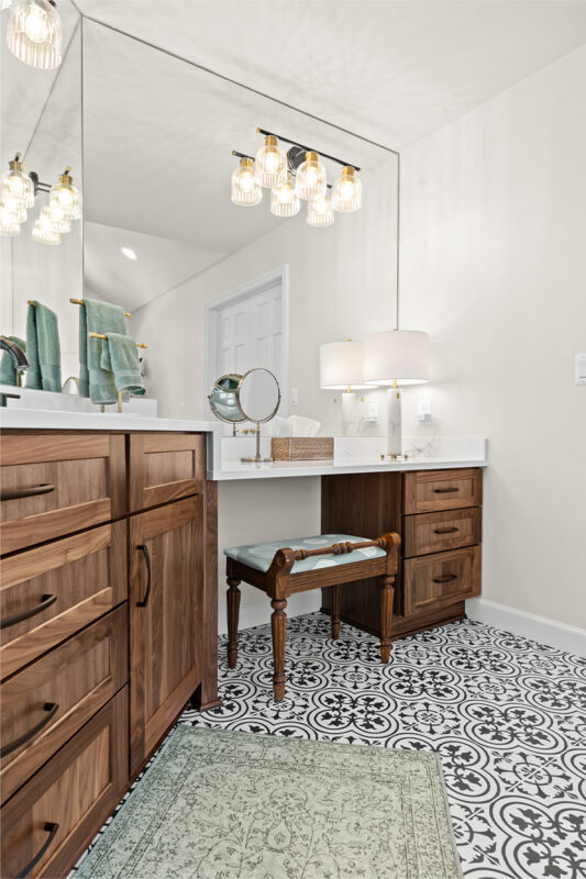 Brown-stained bathroom vanity with makeup desk.