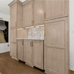 Kitchen cabinets with light brown stain.