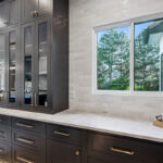 Kitchen with dark Iron Ore painted cabinets.