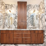 Walnut bathroom cabinets in Natural with walls and floors made of marble.