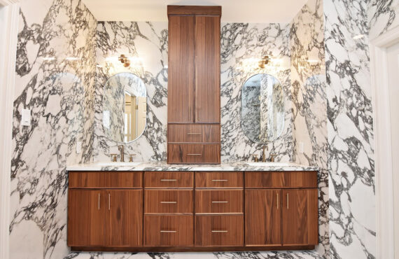 Walnut bathroom cabinets in Natural with walls and floors made of marble.