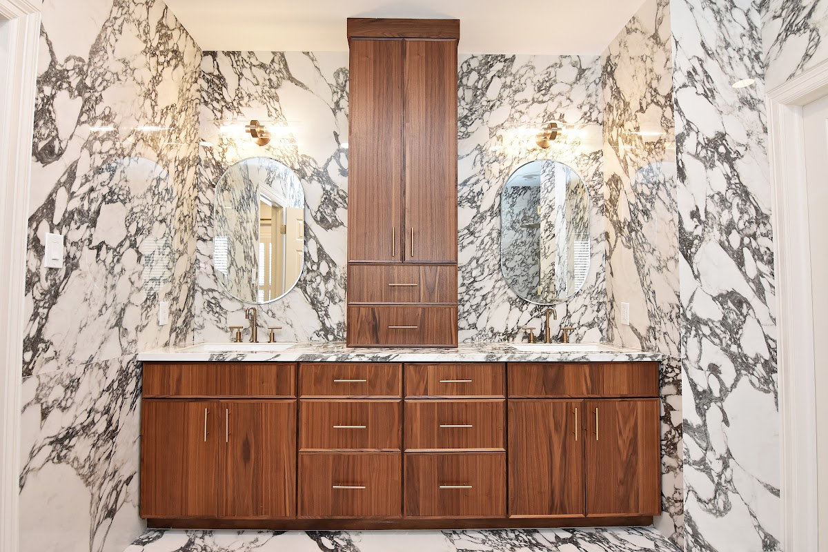 Walnut bathroom cabinets in Natural with walls and floors made of marble.