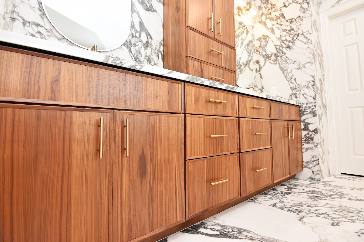 Walnut bathroom cabinets in Natural with walls and floors made of marble.