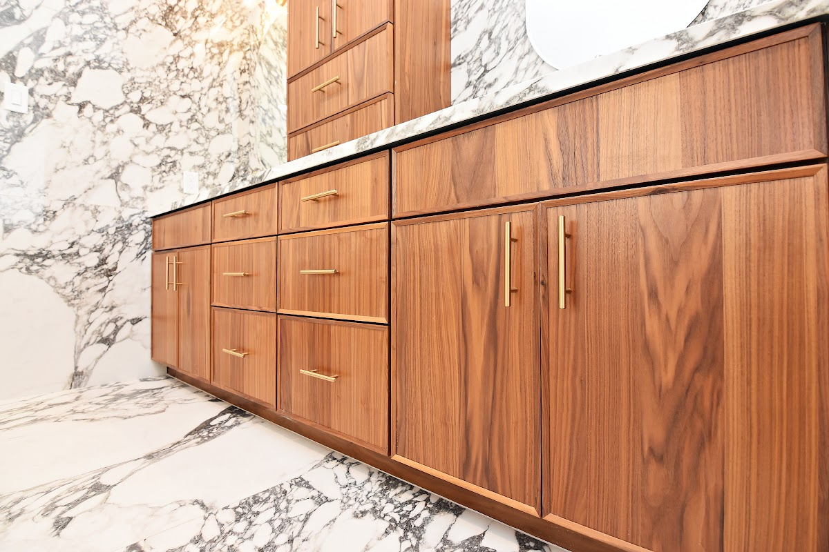 Walnut bathroom cabinets in Natural with walls and floors made of marble.