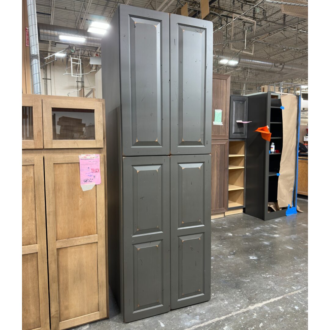 Dark gray painted utility cabinet in a manufacturing facility