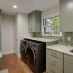 Light green painted laundry cabinets
