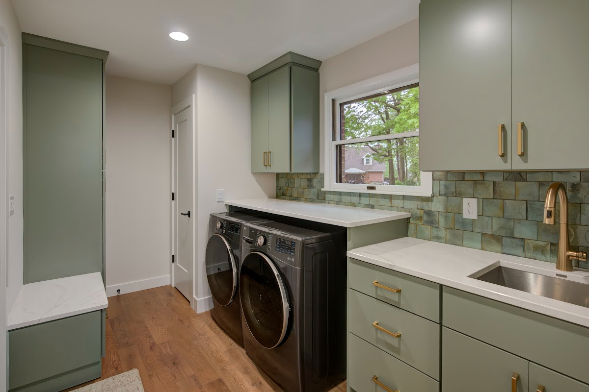 Light green painted laundry cabinets