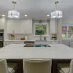 White painted kitchen cabinets with island seating