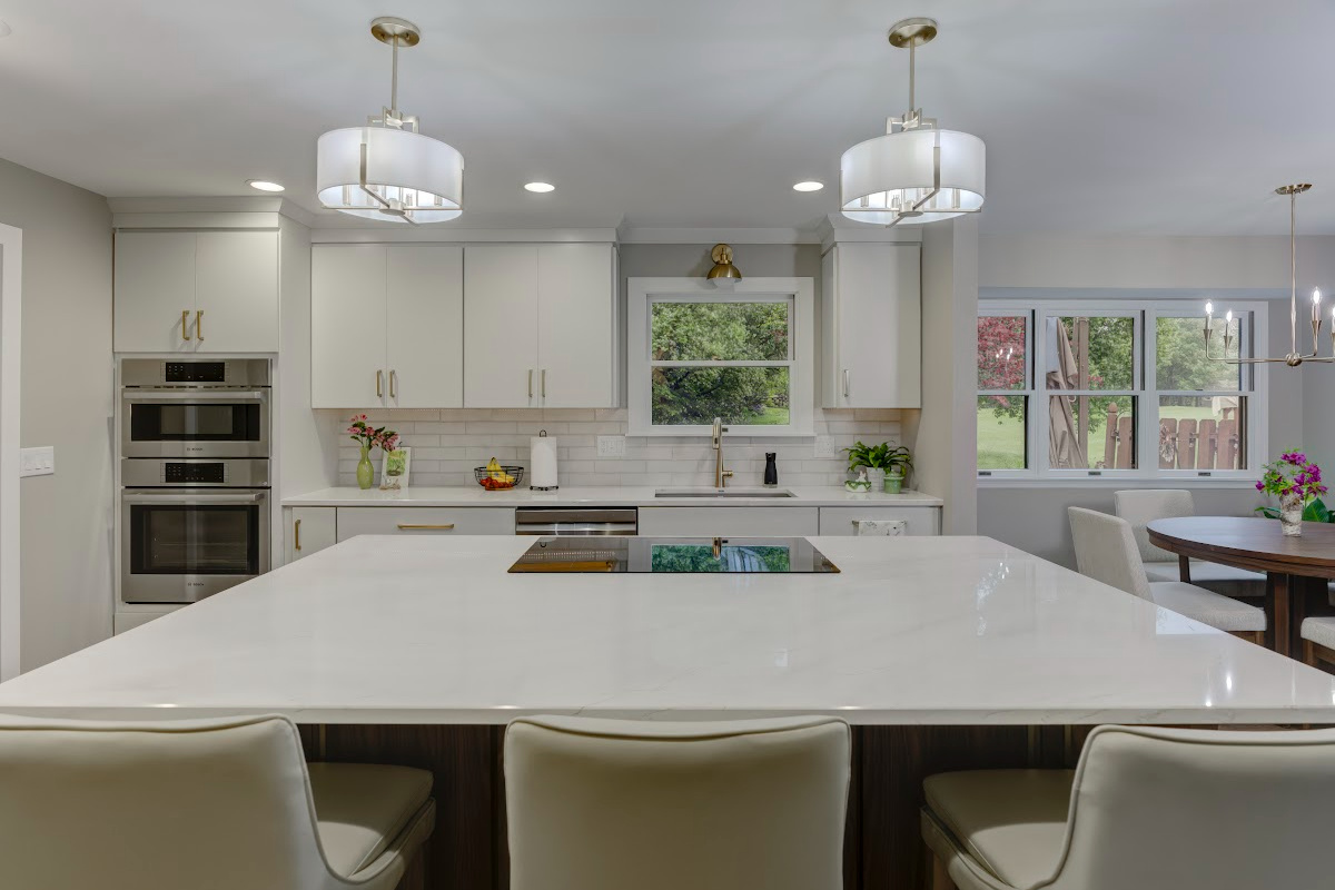 White painted kitchen cabinets with island seating