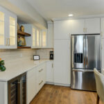 White painted kitchen cabinets with island seating