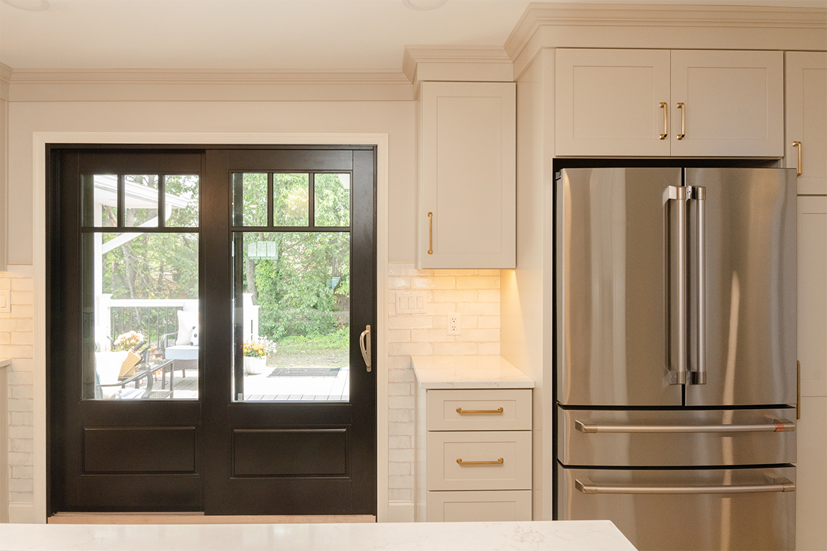 Light Mocha painted perimeter kitchen cabinets and an island with dark stained accent.