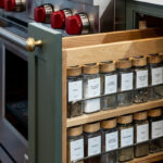 Spice pullout base with green painted door and spice bottles shown.
