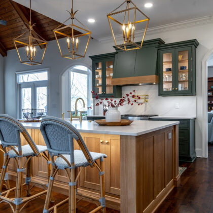 Green and white oak kitchen cabinets and island.