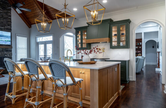Green and white oak kitchen cabinets and island.
