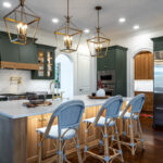 Green and white oak kitchen cabinets and island.