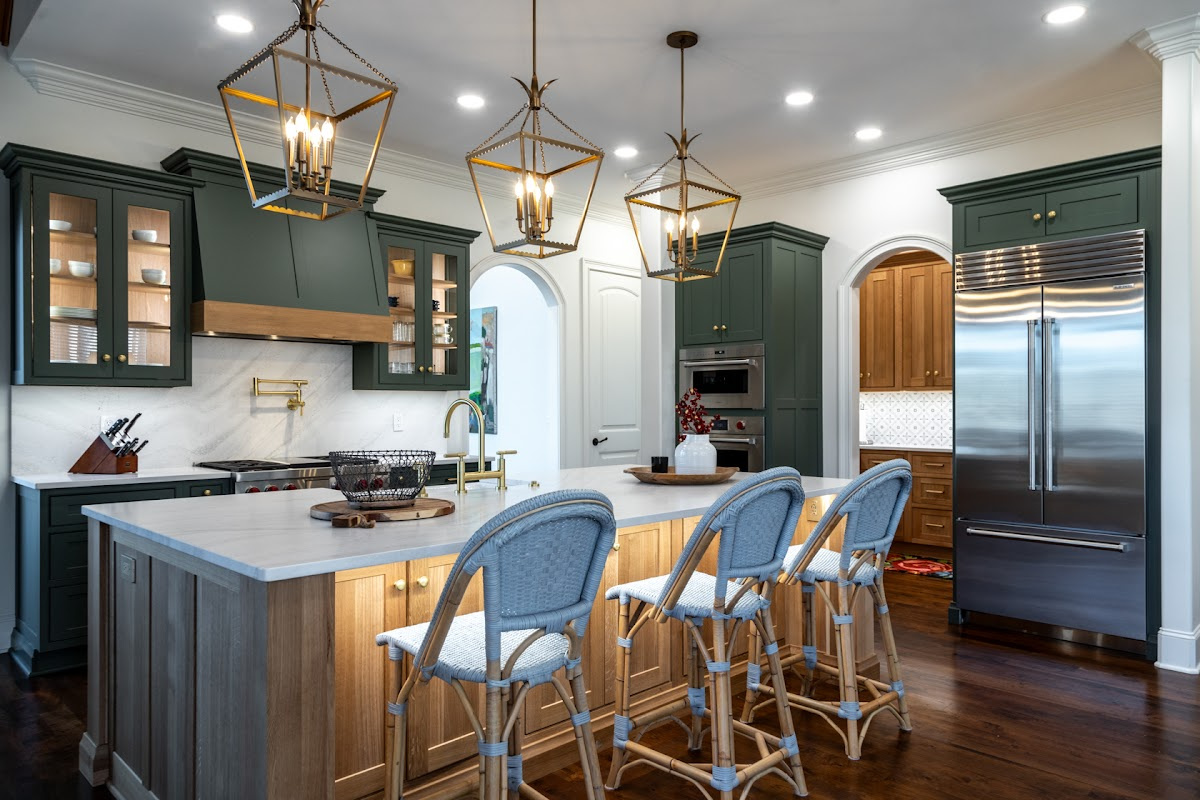Green and white oak kitchen cabinets and island.