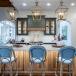 Green and white oak kitchen cabinets and island.