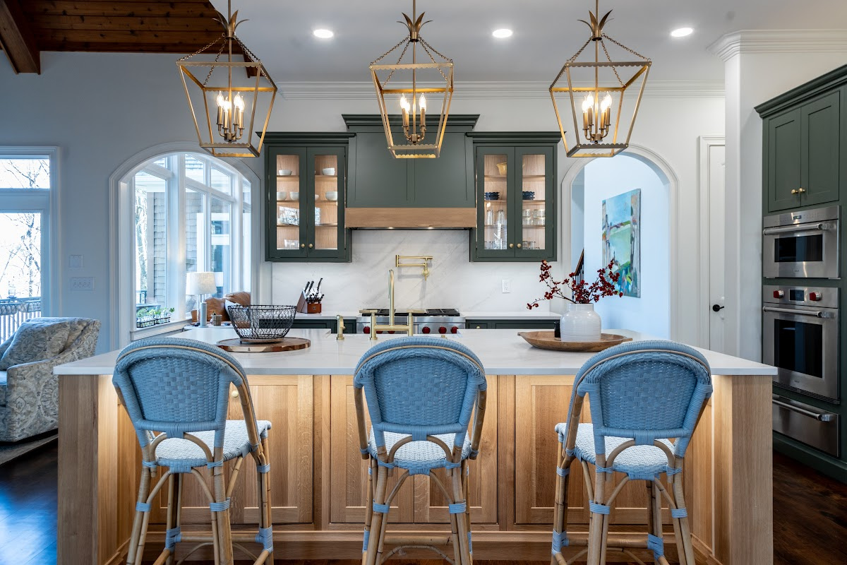 Green and white oak kitchen cabinets and island.