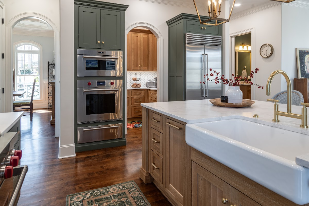 Green and white oak kitchen cabinets and island.