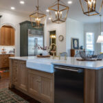 Green and white oak kitchen cabinets and island.