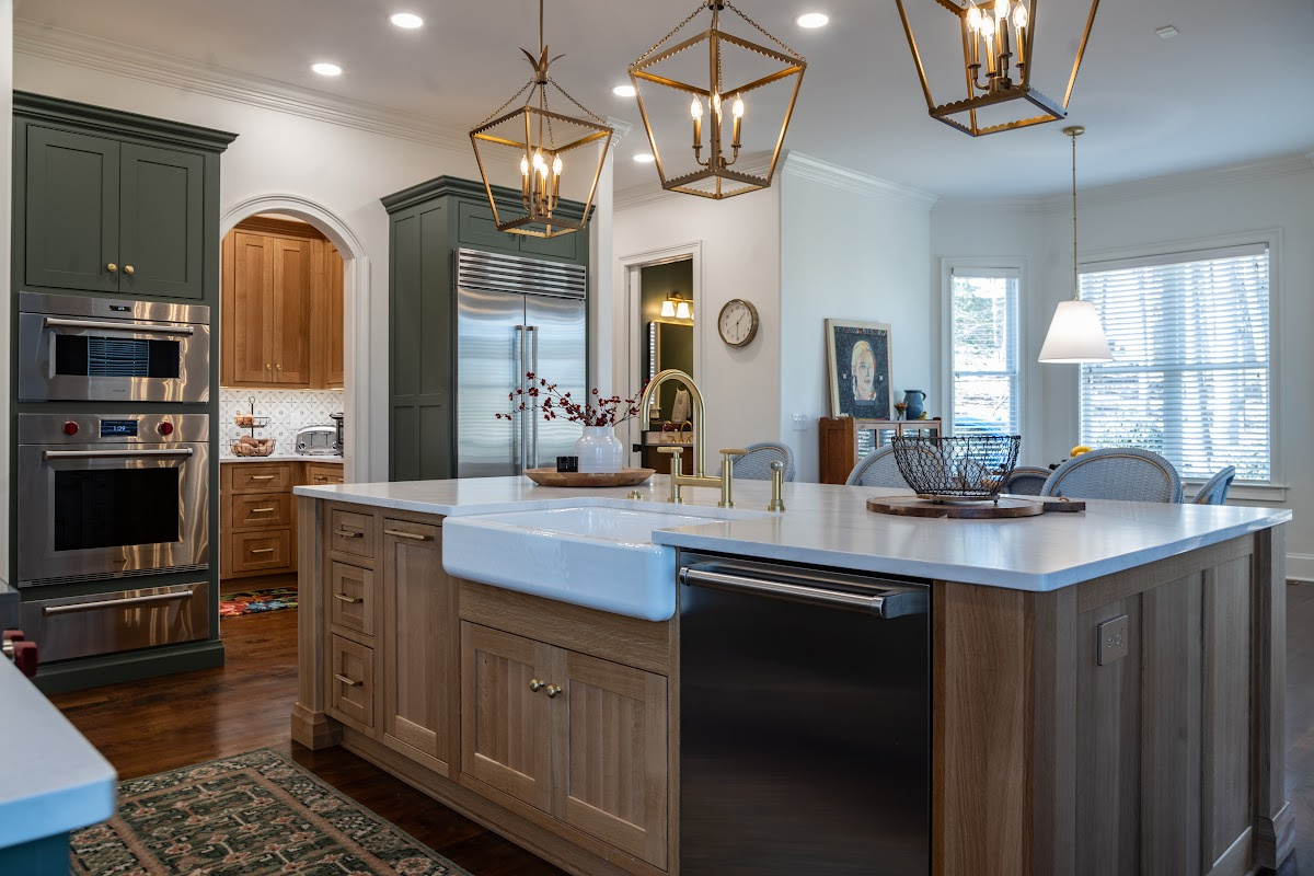 Green and white oak kitchen cabinets and island.