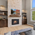 Fireplace with dark stained cabinets on each side.