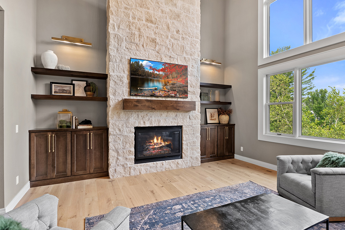 Fireplace with dark stained cabinets on each side.