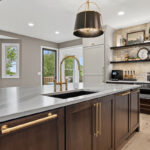 White and dark stained kitchen cabinets with white counter.