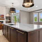 White and dark stained kitchen cabinets with white counter.